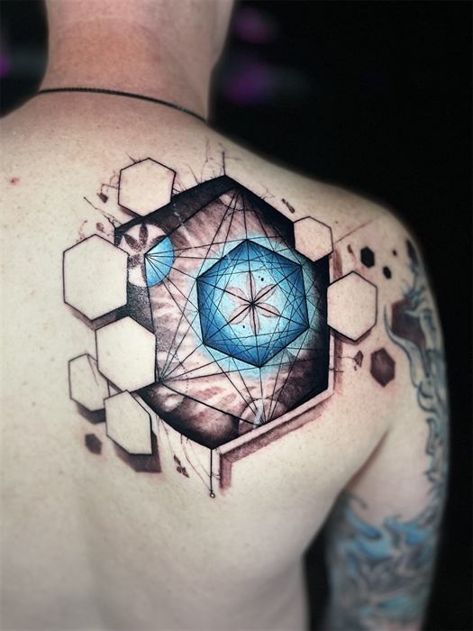Geometric hexagons around a blue crystal on the shoulder