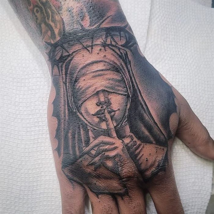 Black and grey hand tattoo