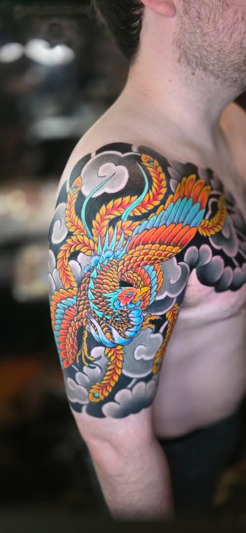 Japanese dragon across the shoulder in orange and blue